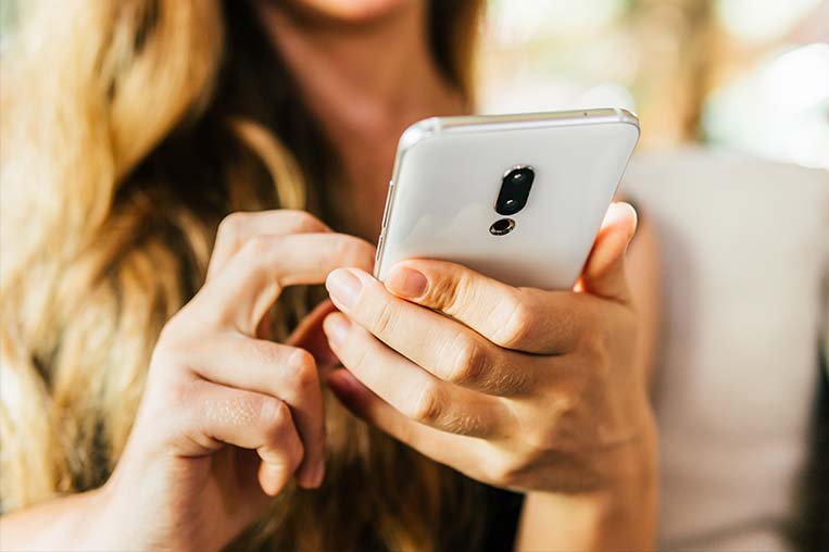 Woman typing on a phone Woman typing on a phone